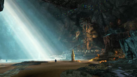 Far Cry 4 video game 4K Ultra HD PC desktop wallpaper: sunbeams pierce a vast cave shrine with a towering carved statue, sandy shore, flickering torches and scattered offerings.