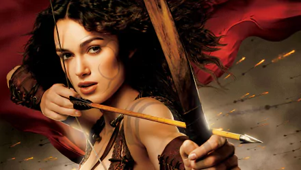 HD PC desktop wallpaper featuring a dramatic close-up of a female archer from the movie King Arthur, with intense expression and a backdrop of red fabric and arrows in flight.