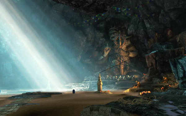 Far Cry 4 video game 4K Ultra HD PC desktop wallpaper: sunbeams pierce a vast cave shrine with a towering carved statue, sandy shore, flickering torches and scattered offerings.