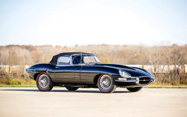 Black Jaguar E-Type supercar parked outdoors, captured in 4K Ultra HD for PC desktop wallpaper and background.