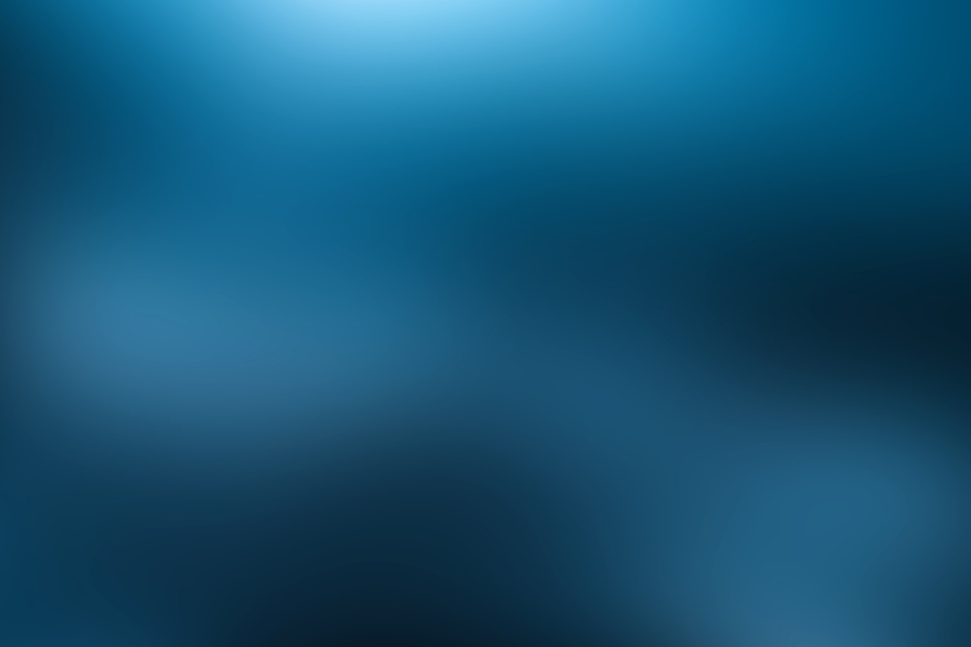 Abstract blurred blue gradient 2K Quad HD PC desktop wallpaper/background with soft luminous streaks and deep teal tones.