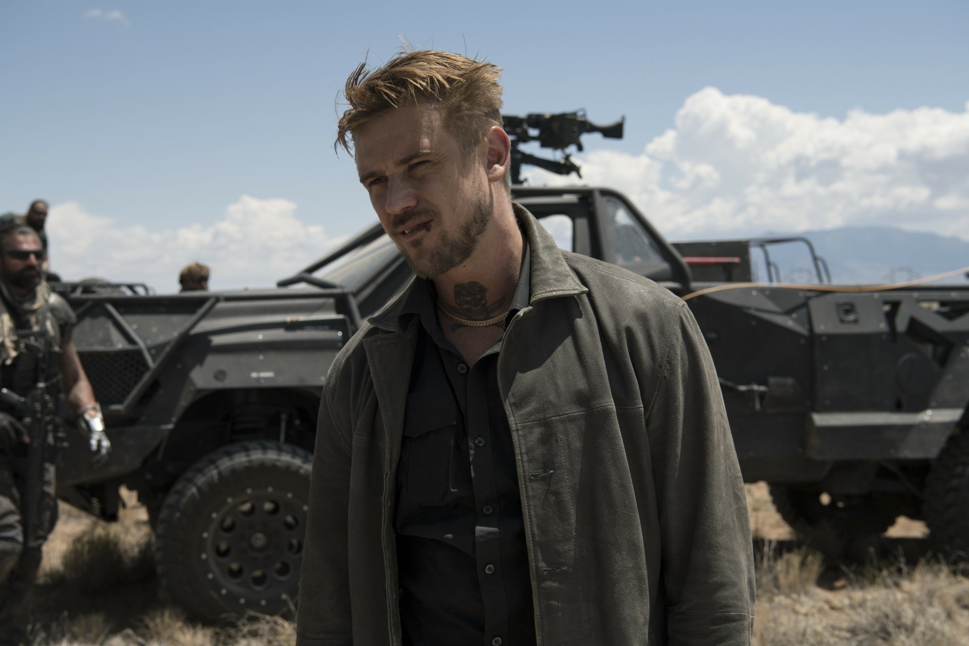 Boyd Holbrook as a character in the movie Logan, standing in front of a rugged, armored vehicle in a desert-like setting. HD desktop wallpaper and background.