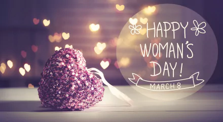 A sparkling heart-shaped decoration with glowing heart bokeh lights in the background and Happy Woman's Day! March 8 text, 4K Ultra HD holiday wallpaper.