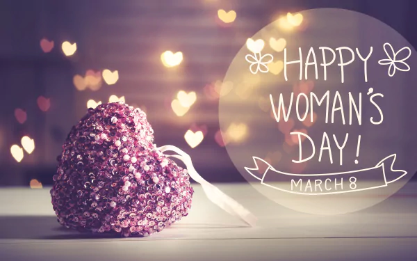 A sparkling heart-shaped decoration with glowing heart bokeh lights in the background and Happy Woman's Day! March 8 text, 4K Ultra HD holiday wallpaper.
