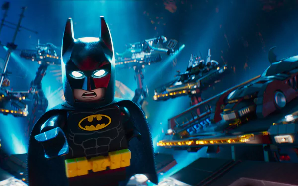 HD desktop wallpaper from The Lego Batman Movie, showcasing Lego Batman with a dramatic backdrop of illuminated structures and spaceships.