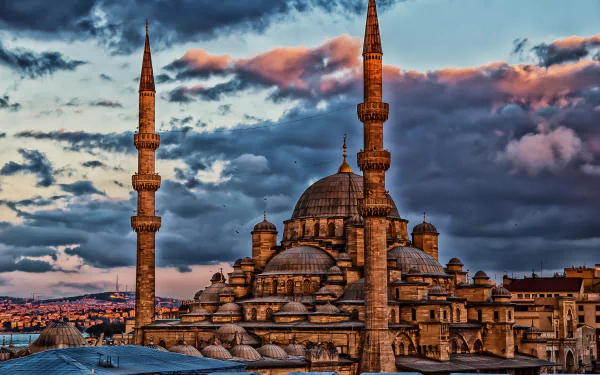 HD desktop wallpaper featuring the iconic Sultan Ahmed Mosque with its domes and minarets against a dramatic sunset sky in Istanbul, Turkey.
