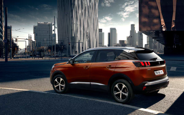 Orange Peugeot 3008 SUV parked in an urban setting with modern skyscrapers, showcased as a 4K Ultra HD PC desktop wallpaper and background.