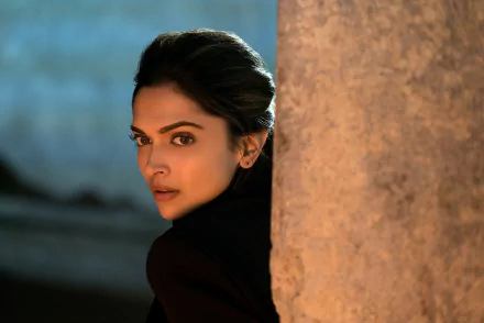 HD wallpaper featuring Deepika Padukone from the movie xXx: Return of Xander Cage. She is shown peeking from behind a pillar in a dramatic, shadowy setting.