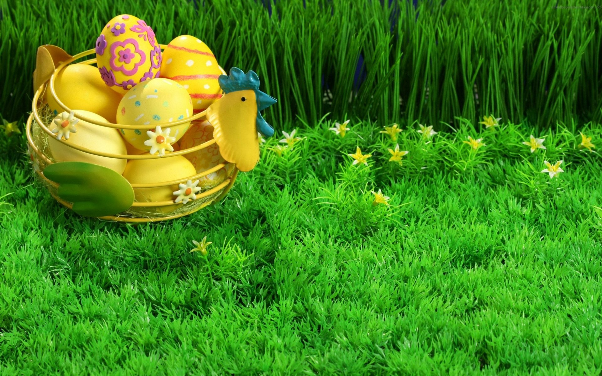 Colorful Easter eggs rest in a yellow rooster-shaped basket on vibrant green grass, creating a festive holiday scene on this HD PC desktop wallpaper.