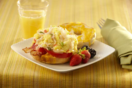 HD PC desktop wallpaper: bagel lunch — open bagel sandwich with scrambled eggs, tomato and bacon on bread, fresh strawberries and blackberries, and a glass of orange juice.