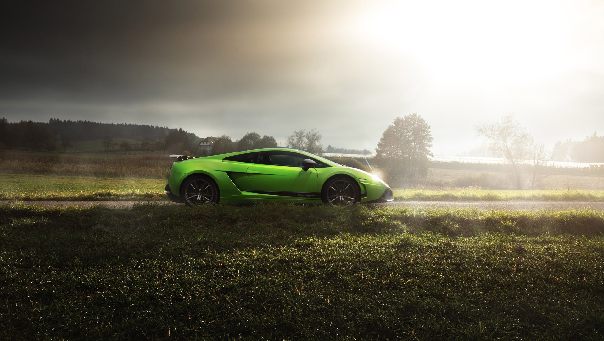 A vibrant green Lamborghini Gallardo Superleggera supercar parked on a grassy field under a moody sky, captured in stunning 4K Ultra HD resolution.