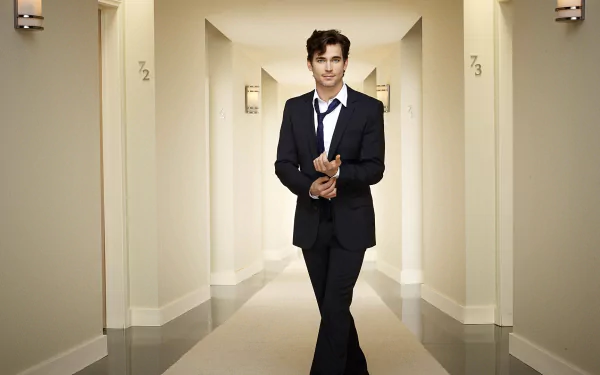 HD desktop wallpaper featuring a man in a suit standing in a hallway, creating a professional and stylish background.