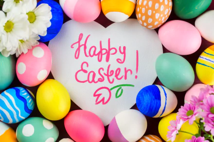 HD desktop wallpaper featuring colorful Easter eggs, chrysanthemums, and a cheerful Happy Easter! message framed by a heart shape. A vibrant, festive background celebrating the holiday.