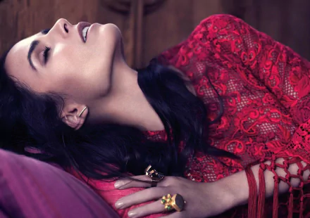 HD desktop wallpaper featuring American actress Jordana Brewster with brunette hair, reclining in a red lace outfit, showcasing a serene and elegant pose.