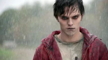 HD desktop wallpaper featuring Nicholas Hoult in a scene from the movie Warm Bodies, standing in the rain with a serious expression.