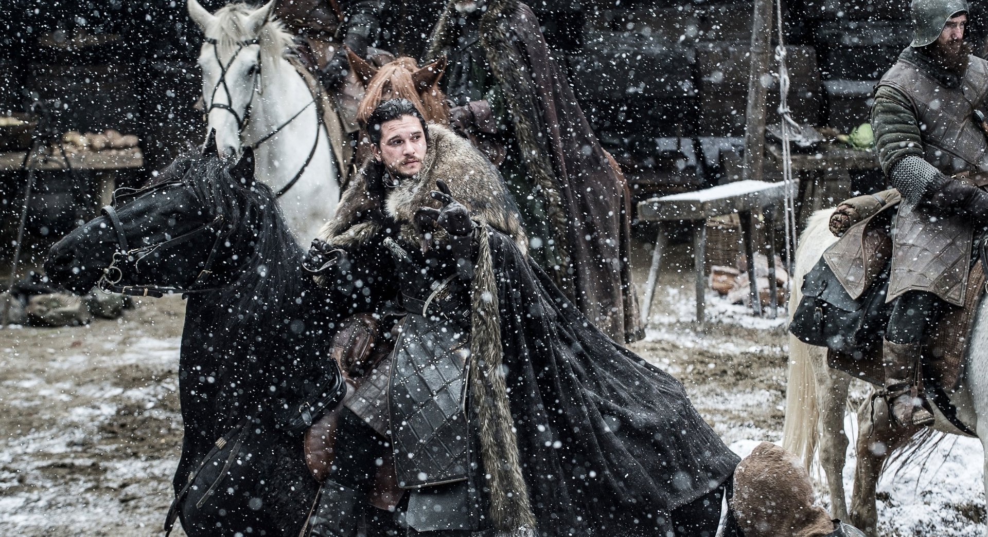 HD desktop wallpaper featuring Kit Harington as Jon Snow from the TV show Game of Thrones in a snowy outdoor scene with horses.