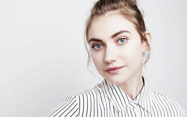 A high-definition desktop wallpaper featuring the English actress Imogen Poots with blue eyes, wearing a striped shirt, and posing against a neutral background.
