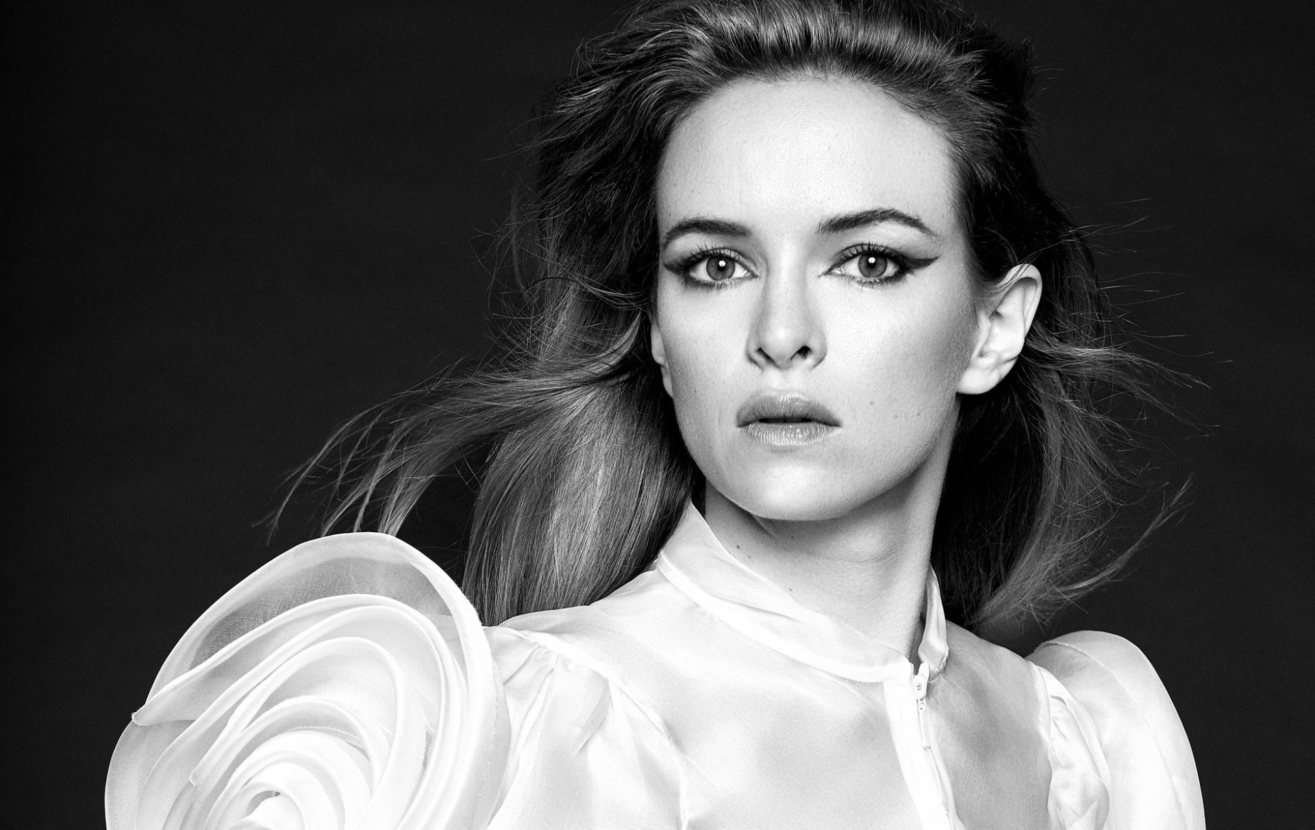Black and white HD desktop wallpaper featuring actress Danielle Panabaker, exuding elegance in a high-fashion outfit with a dramatic expression and styled hair.