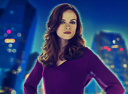 HD desktop wallpaper featuring actress Danielle Panabaker, with a cityscape background and vibrant lighting.