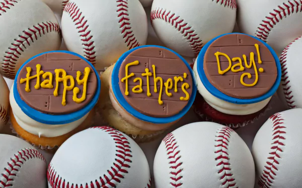 HD desktop wallpaper featuring baseballs surrounding three cupcakes decorated with Happy Father's Day! frosting, celebrating Father's Day with a sporty, festive theme.