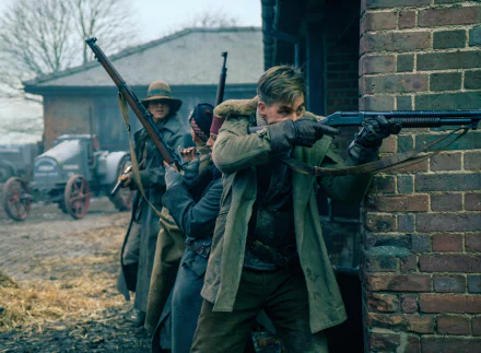 Chris Pine in a scene from the movie Wonder Woman, featuring characters in a wartime setting with rifles, taking cover behind a brick wall. HD desktop wallpaper and background.