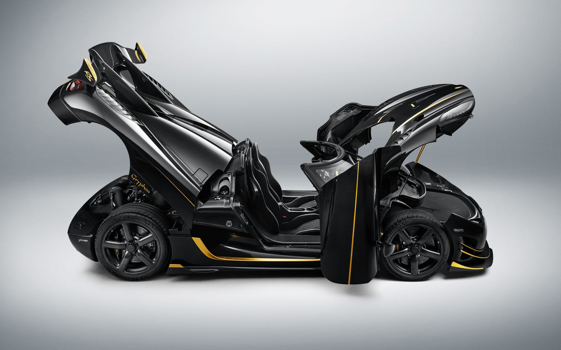 HD desktop wallpaper showcasing a sleek black Koenigsegg Agera RS Gryphon supercar with doors and hood open, highlighting its advanced design and engineering.