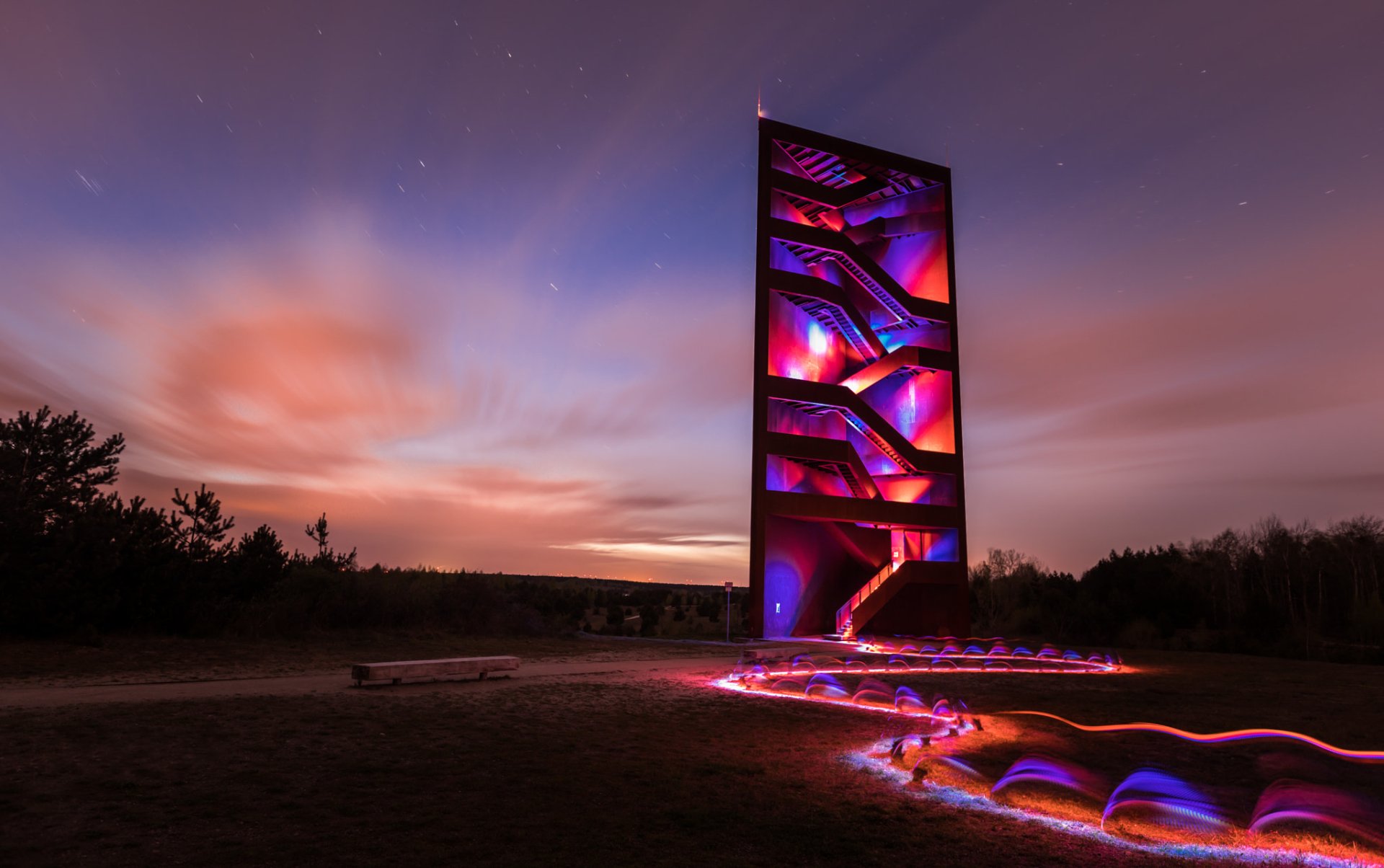 A striking HD PC desktop wallpaper featuring a man-made architectural light installation with illuminated stairs under a colorful twilight sky.