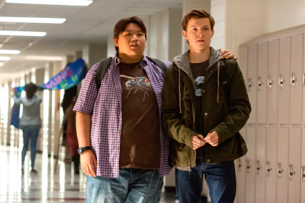 HD desktop wallpaper featuring Jacob Batalon and Tom Holland as Peter Parker in a hallway scene from the movie Spider-Man: Homecoming.