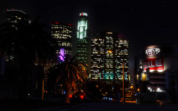 Night view of illuminated skyscrapers in Los Santos city from Grand Theft Auto V, captured in high-definition for a vivid PC desktop wallpaper.