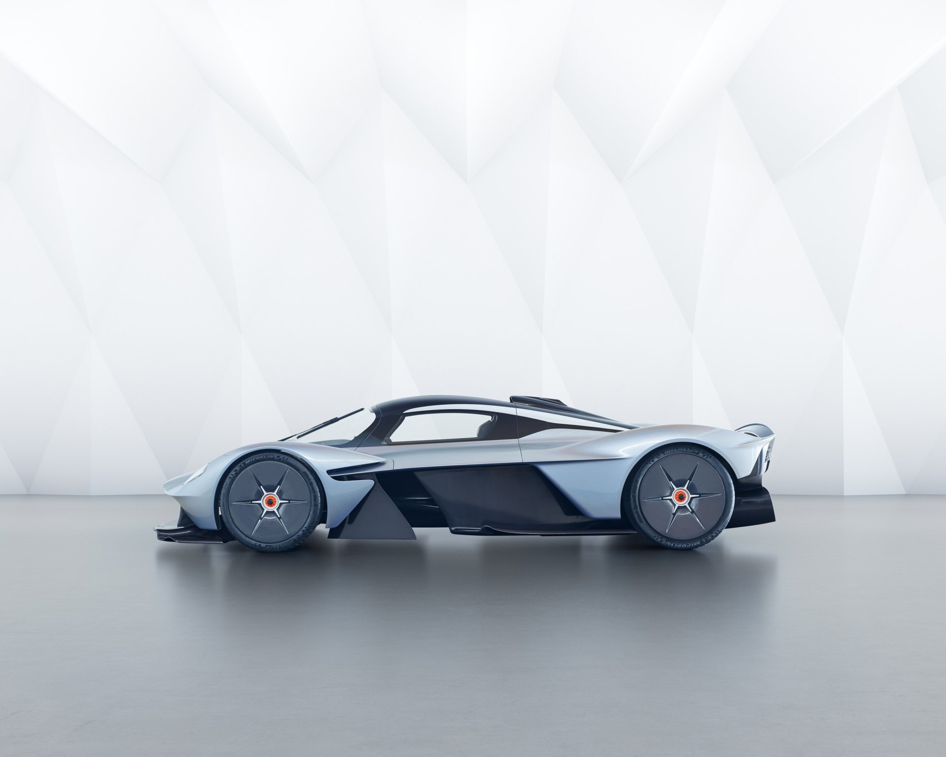 HD desktop wallpaper featuring a sleek Aston Martin Valkyrie supercar in a modern, minimalistic setting.