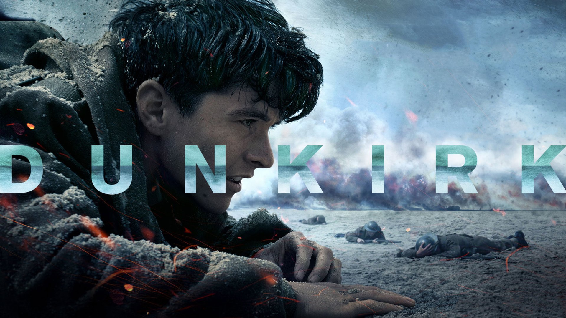 HD desktop wallpaper showcasing the movie Dunkirk, featuring a close-up of a soldier lying on the beach amid the war-torn landscape.