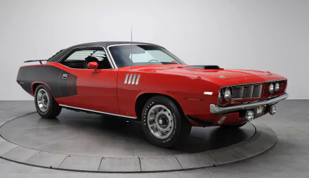 HD desktop wallpaper featuring a red Plymouth Hemi Cuda muscle car with black accents, showcasing the iconic Plymouth Barracuda design.
