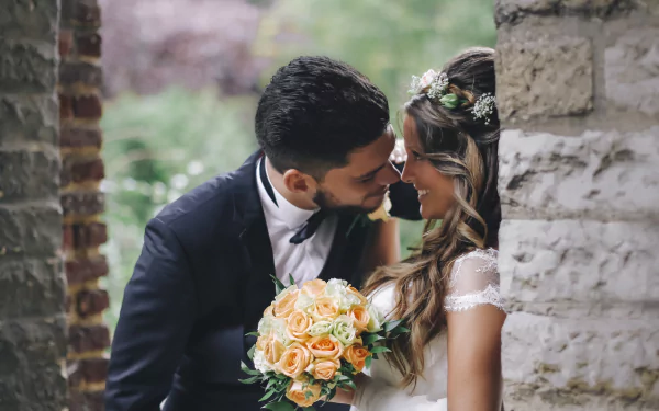 Romantic wedding moment captured in 4K Ultra HD, featuring a bride and groom sharing an intimate, loving gaze with a bouquet in hand.