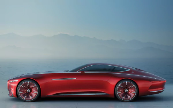 Sleek red Mercedes-Maybach 6 grand tourer concept car showcased against a misty mountain backdrop, captured in high-definition for a desktop wallpaper.