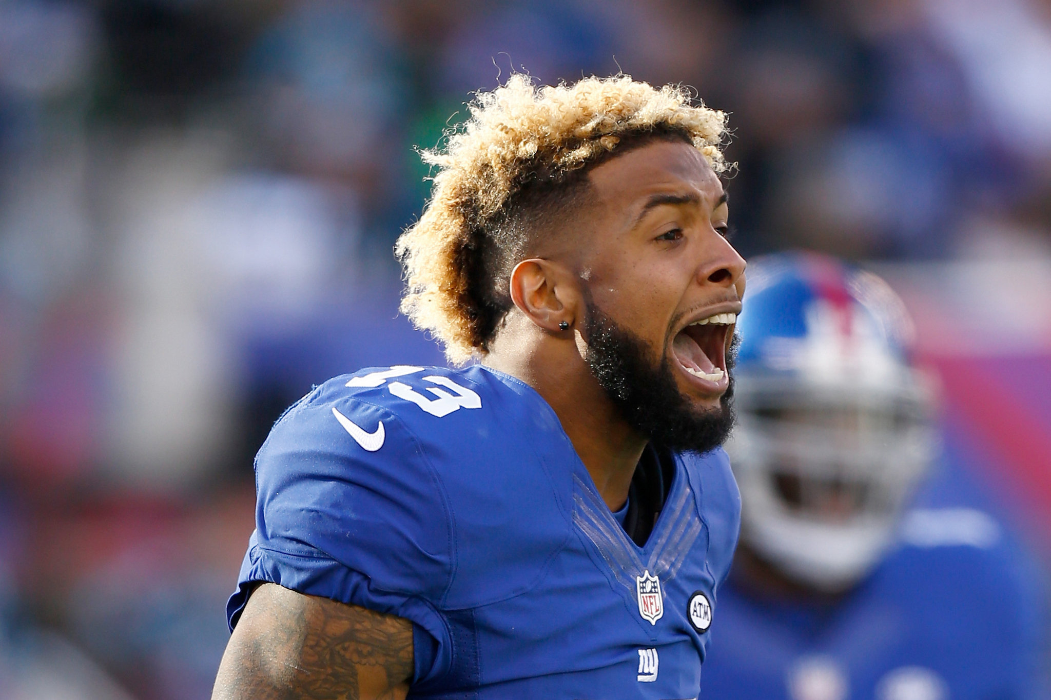 HD desktop wallpaper featuring a New York Giants player in a blue jersey mid-shout on the field.