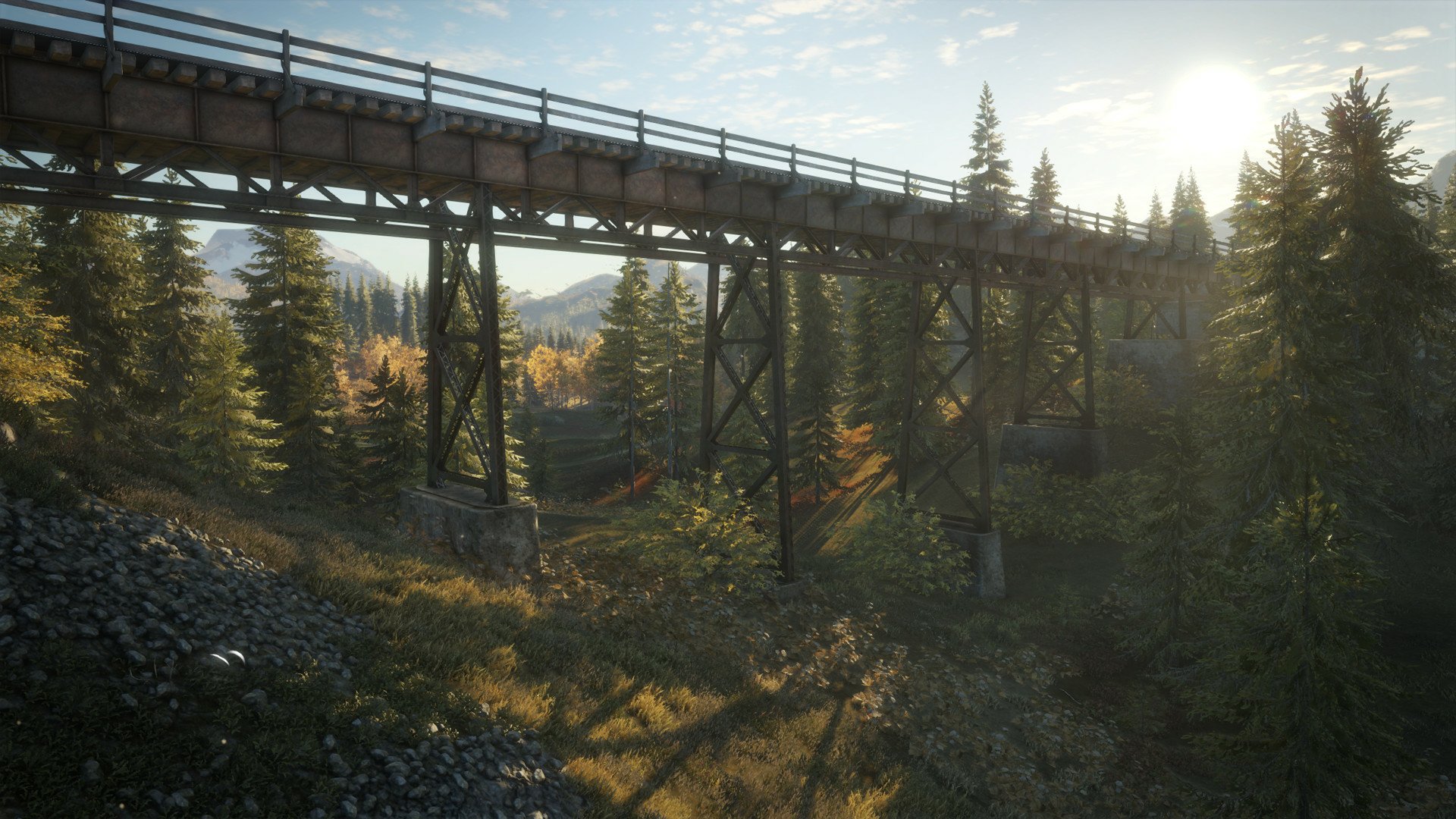 HD PC desktop wallpaper from the video game theHunter: Call of The Wild — sunlit forest valley with a wooden trestle bridge and tall pines.