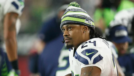 HD wallpaper of a Seattle Seahawks player on the field, capturing the intensity of the game.