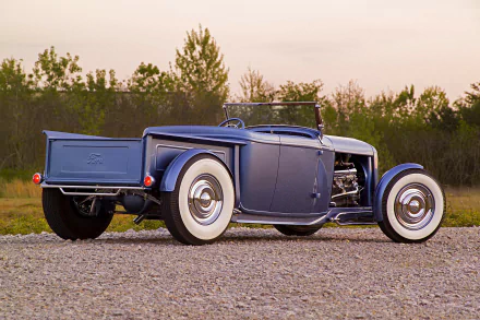 Blue vintage Ford Roadster Pickup hot rod vehicle with whitewall tires on gravel at sunset — HD PC desktop wallpaper/background.