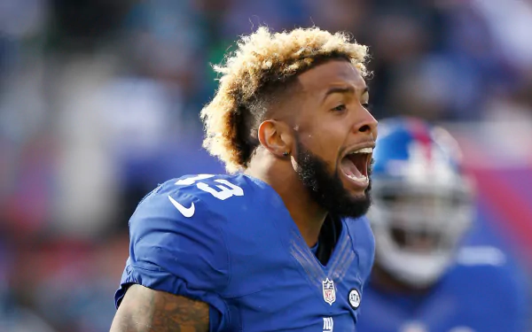 HD desktop wallpaper featuring a New York Giants player in a blue jersey mid-shout on the field.