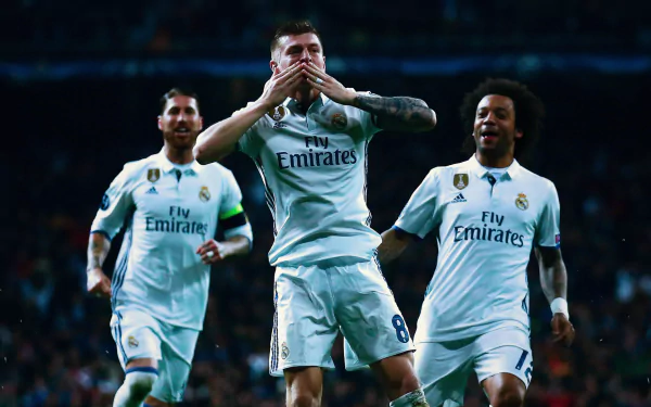 HD desktop wallpaper featuring Real Madrid C.F. players Toni Kroos, Sergio Ramos, and Marcelo celebrating a goal in a soccer match.