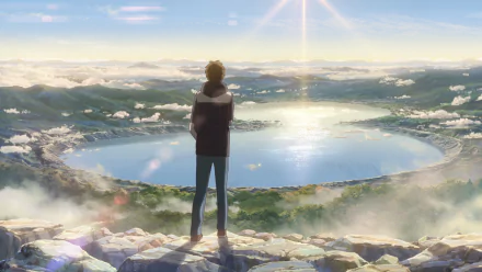 Taki Tachibana from Your Name. Anime scene: he stands on a rocky rim overlooking a luminous crater lake at sunrise — HD PC desktop wallpaper background.
