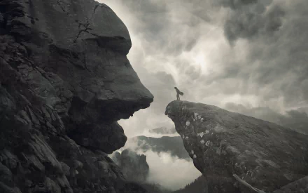 HD PC desktop wallpaper/background: a monochrome fantasy landscape with a colossal rock face overlooking a lone figure on a jagged cliff beneath brooding clouds.