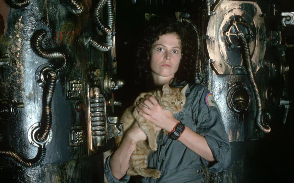 Sigourney Weaver as Ellen Ripley, holding a cat, in a scene from the movie Alien. The HD wallpaper features detailed industrial set designs in the background.