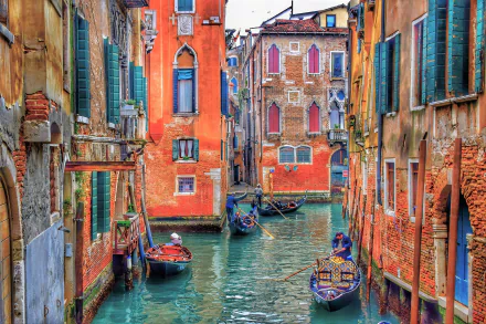 Vibrant 4K Ultra HD image of a colorful canal in Venice, Italy, featuring gondolas navigating between historic buildings.