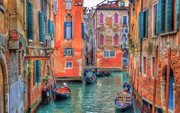 Vibrant 4K Ultra HD image of a colorful canal in Venice, Italy, featuring gondolas navigating between historic buildings.