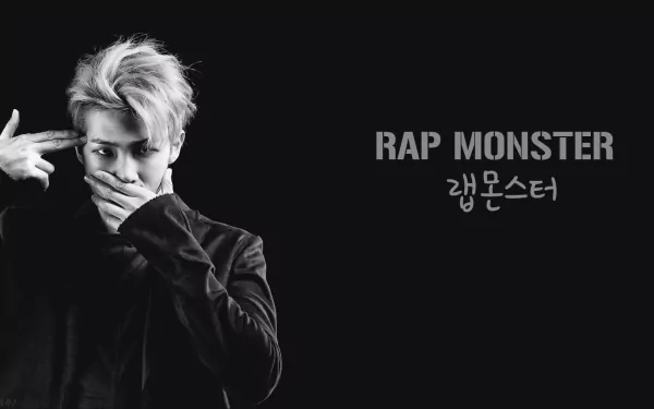 Black and white HD desktop wallpaper featuring BTS's Rap Monster, with his name in English and Korean against a dark background.