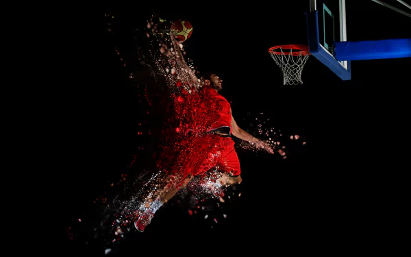 HD desktop wallpaper of a basketball player in a red uniform making a dynamic dunk under bright lights, with a splash effect emphasizing movement and energy.