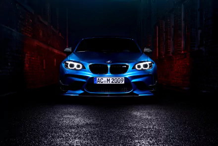 Front view of a blue BMW M2 with illuminated headlights, showcased as a 4K Ultra HD PC desktop wallpaper in a dark, urban setting.