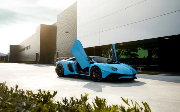 Blue Lamborghini Aventador SV supercar with scissor doors open, parked in front of a modern building, captured in HD for a PC desktop wallpaper background.