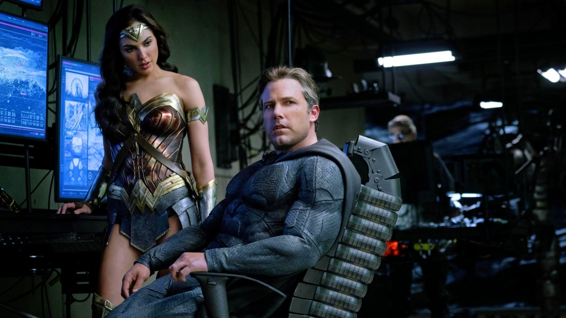 HD PC desktop wallpaper featuring Ben Affleck as Bruce Wayne/Batman seated, with Wonder Woman standing beside him, from the Justice League movie.